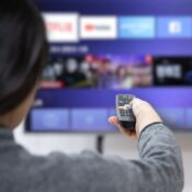 A woman experiences OTT service using a smart TV at home